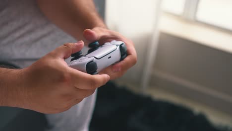 cerca de manos masculinas jugando videojuegos por una luz de ventana abierta en cámara lenta