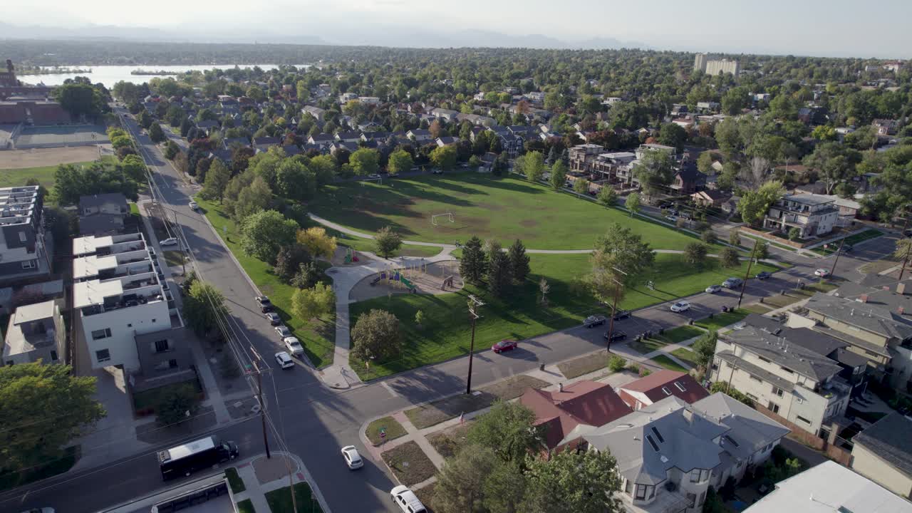 A 4K drone shot of a sunny day over Hallack Park, among a quiet and pristine neighborhood between Sloans Lake and Empower Field, in Denver, Colorado