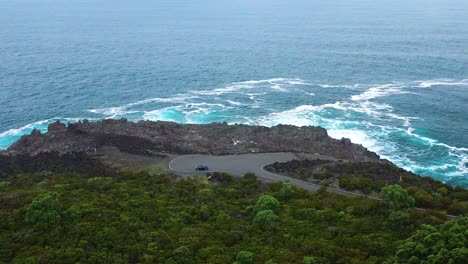 car isolated near water edge cliffs of ponta do queimado headland in azores, terceira island portugal