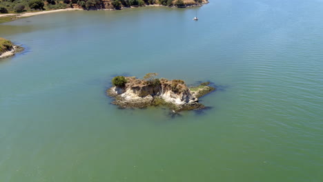 Aerial-view-orbiting-uninhabited-Rat-rock-island-cove,-China-camp-state-park,-California