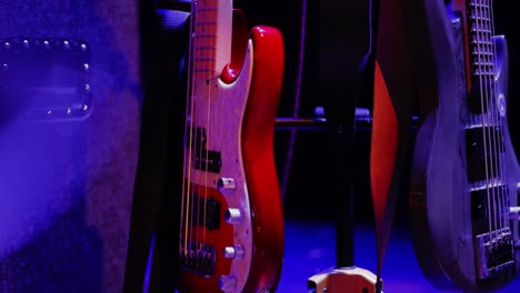 an electric bass waiting in the stage lights