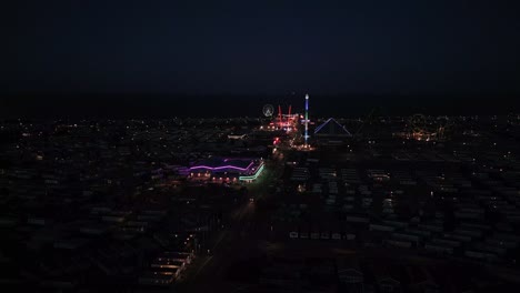 dusk, aerial footage of a typical seaside amusement park. fantasy island amusement park at night in the seaside town of ingoldmells near skegness
