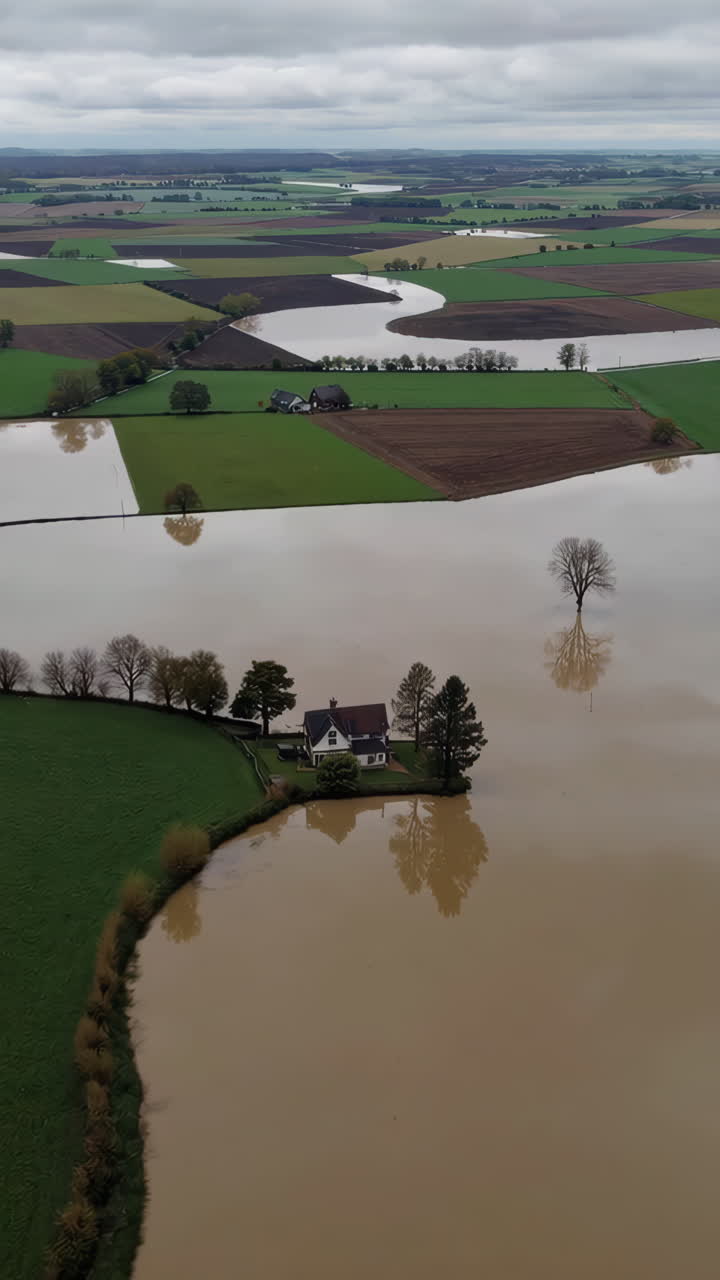Aerial View of a House and Farmland Submerged by Extensive Flooding