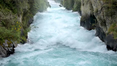 slow motion of the aggressive river leading up to huka falls in new zealand