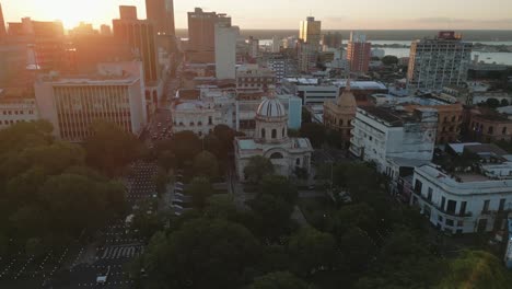 Aerial-Panoramic-View-of-Asuncion-Paraguay-City,-Cityscape-and-Sunset-Skyline-in-Paraguayan-Capital,-National-Pantheon-of-the-Heroes-Landmark