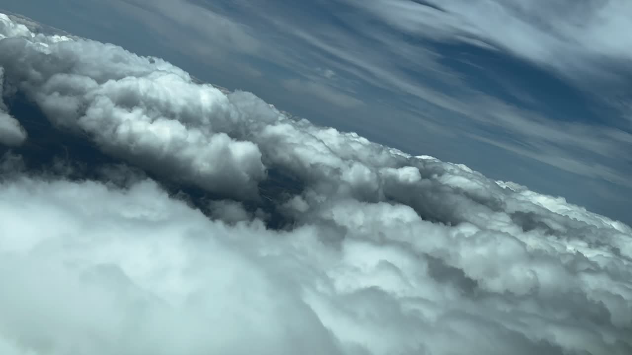 Pilot POV flying across a dramatic stormy sky plenty of stormy clouds in a left turn