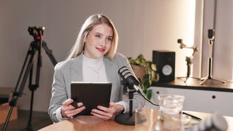 a woman recording a podcast in a studio