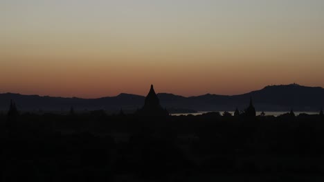 beautiful sunset over a pagoda in bagan, myanmar.