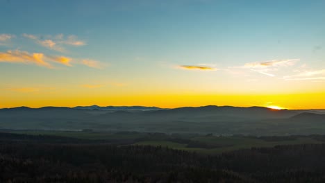 Time-lapse-of-Snezka,-Karkonosze-mountains,-during-a-bright-misty-sunset