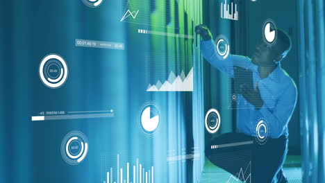 animation of financial data processing over african american businessman working in server room