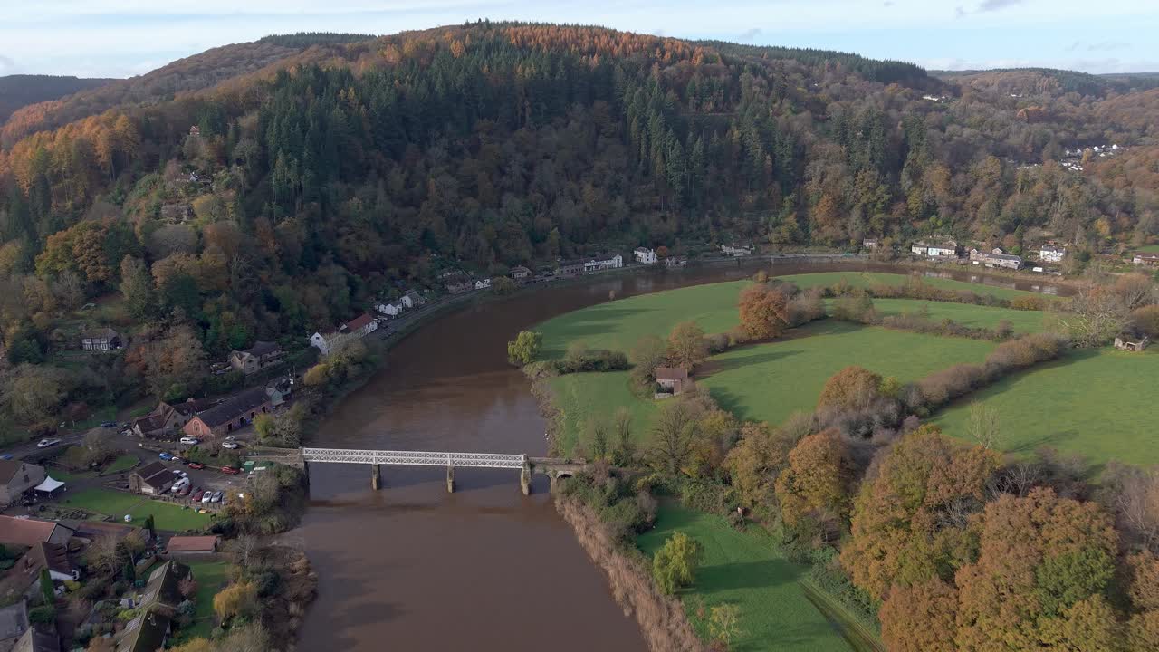 Aerial drone view flying towards Tintern village and the River Wye in autumn