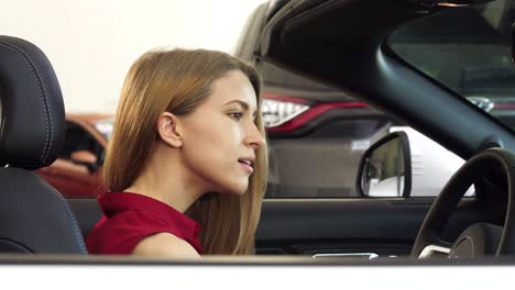 gorgeous woman posing in her new convertible holding car keys