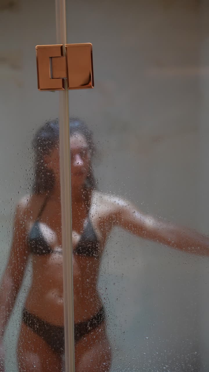 Young Woman in Bikini Enjoying a Relaxing Shower