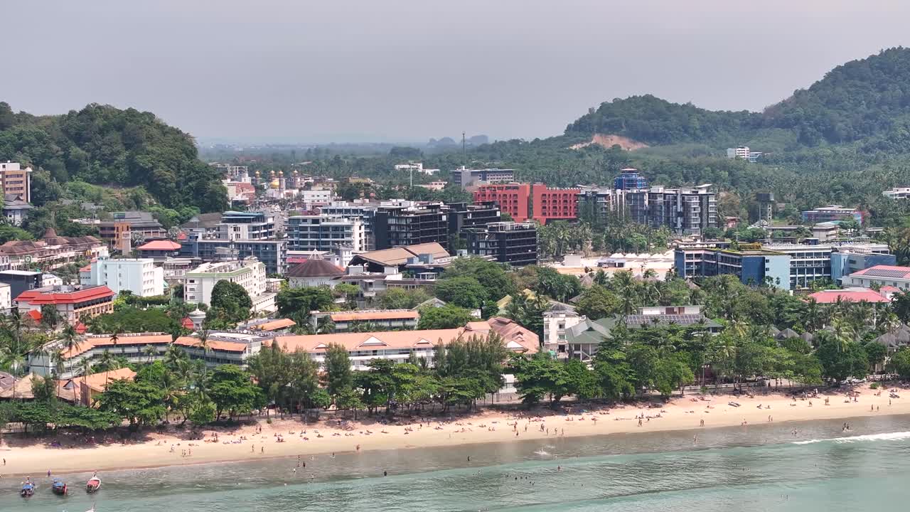 Aerial close up of Ao Nang Beach with beachfront and promenade. Hotels, shops and resorts.
