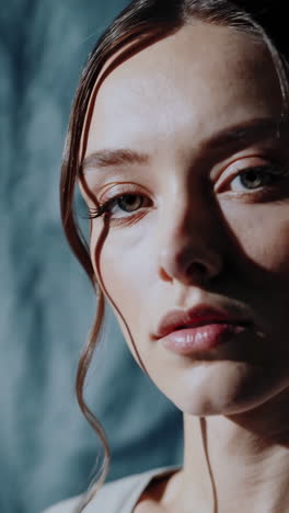 close-up portrait of a woman with dramatic shadows across her face
