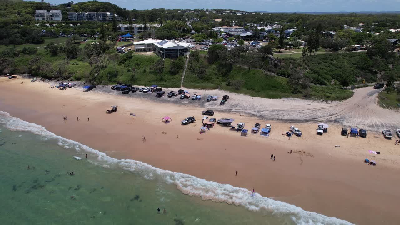 People And Parked Vehicles At Rainbow Beach On Sunny Day In Queensland, Australia. aerial shot
