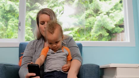 mother with her son using mobile phone 4k