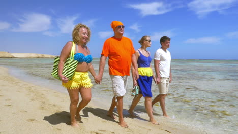 Young-and-senior-people-walking-at-the-seaside-together