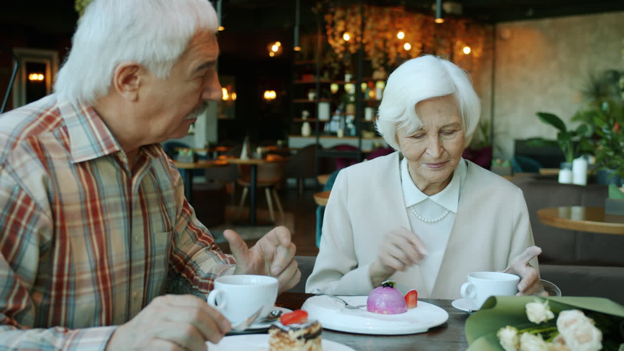 Elderly Couple Enjoying Dessert and Coffee in a Cafe