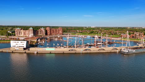 approaching the berth with old-fashioned ships on the anchor. museum batavialand in lelystad, the netherlands. aerial view.