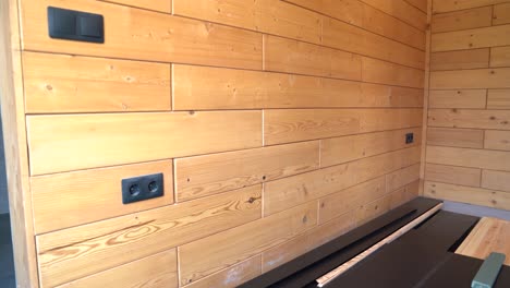 interior room with installed wooden wall panels and multiple electrical outlets