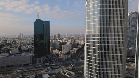 panning-shot-of-office-buildings-facing-the-sea-with-car-traffic-below