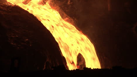 hot metal pout out from blast furnace. molten metal pouring from furnace