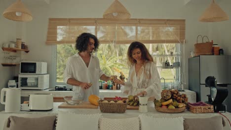 couple preparing tropical fruits in a modern kitchen