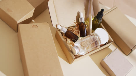 close up of different beauty products in packages on beige background