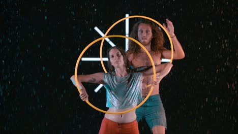 male and female hula hoopers performing artistic visual effects in wet studio