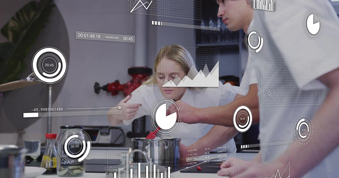 Female chef smelling steam and guiding male chef stirring pot for perfect seasoning in culinary