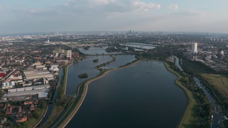 Dolly-forward-drone-shot-over-north-London-water-reservoirs-Walthamstow-towards-city-skyline