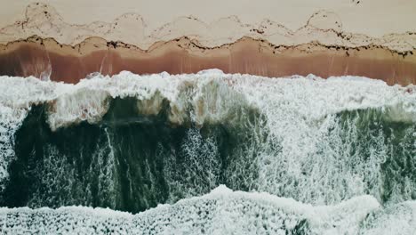 aerial view of waves crashing on beach