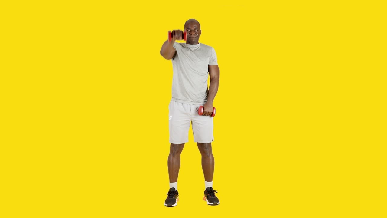 African man doing alternate frontal shoulder raise exercises with dumbbells
