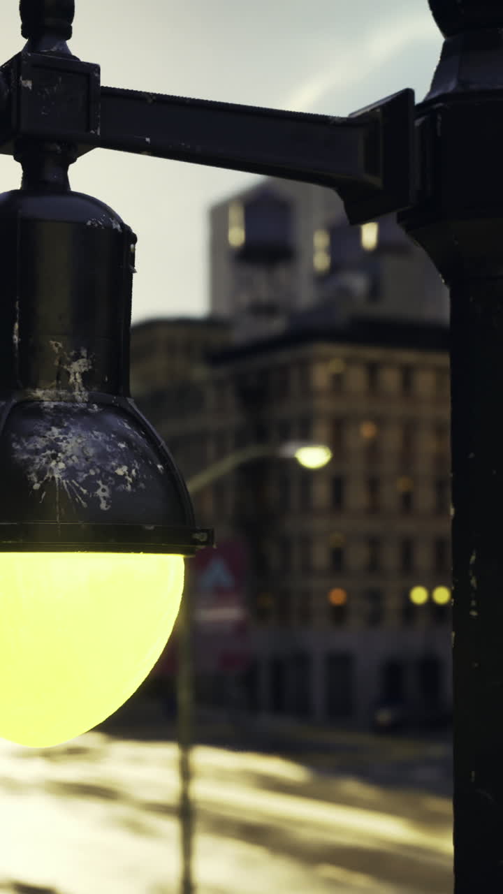 City lights glow at sunset along a bustling urban street in the evening