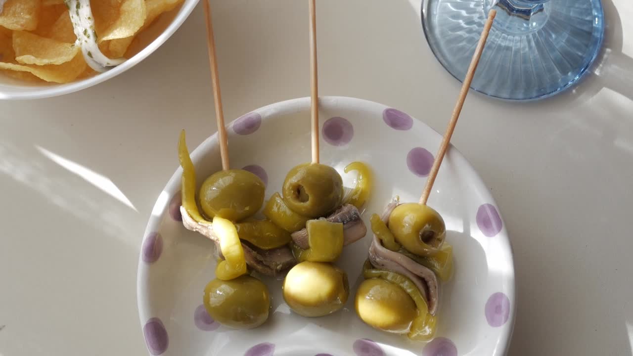 Delicious tapas of Gildas and Boquerones served with vermouth