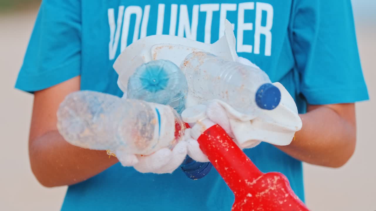 Hands woman volunteer with plastic nondegradable garbage collected from ocean