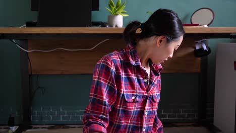 delighted ethnic woman assembling furniture in room