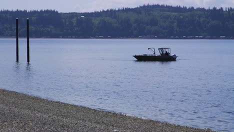 small, nondescript fishing floating near dock at camano island state park, wa state 20sec-24fps slow motion