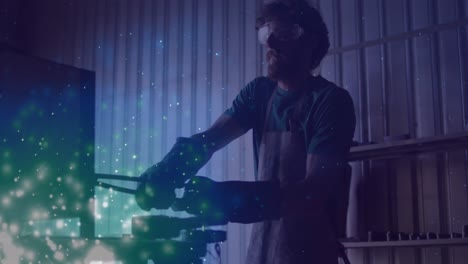 Animación-De-Luces-Brillantes-Sobre-Un-Hombre-Caucásico-Trabajando-En-Un-Taller