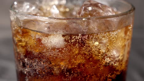 coca-cola, glass exudes effervescence, with tiny bubbles clinging to sides