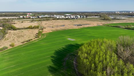 aerial-of-konin-power-plant-in-Poland-with-natural-reserve-lake-and-green-land-during-a-sunny-day-of-summer