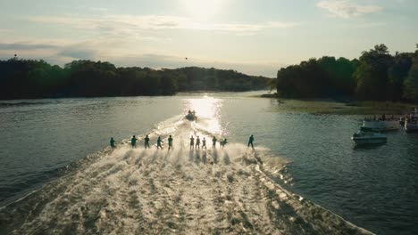 aerial, group of people water skiing as a group on lake at a water ski show during summer