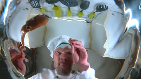 chef prepares vegetable broth. chef adds spice to the soup, the view from the pan in slow motion.