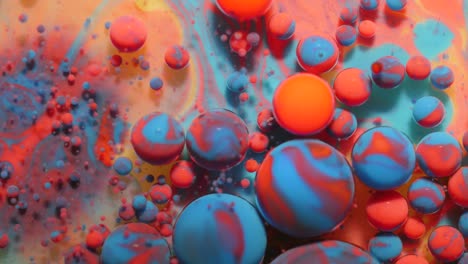 slow motion bright pastel color bubbles oil beautiful milk paint sparkling color moving multicolor close up. acrylic blue paint. fantastic surface. abstract colorful transformation gravitation.
