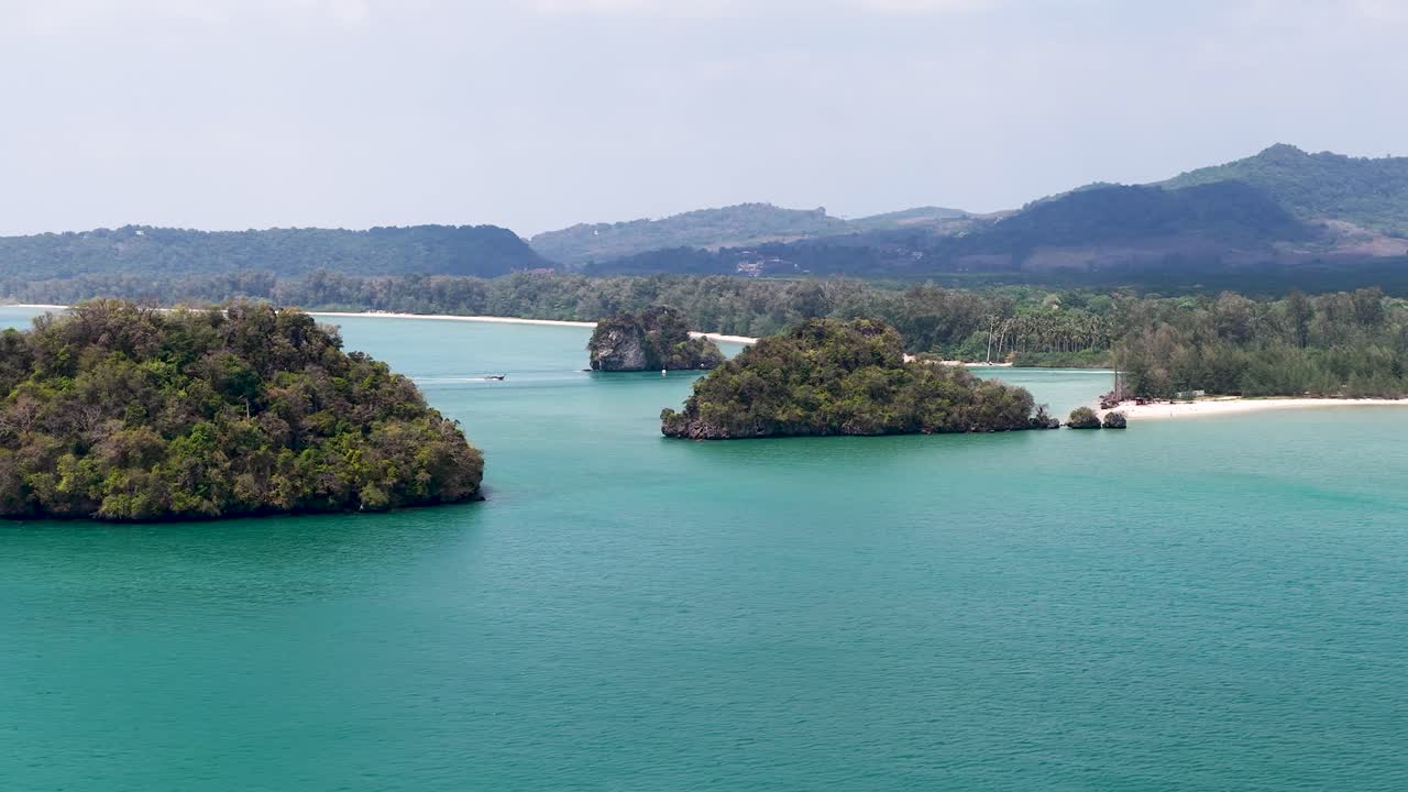 Wide aerial drone shot of tropical limestone islands and turquoise water in Krabi, Thailand