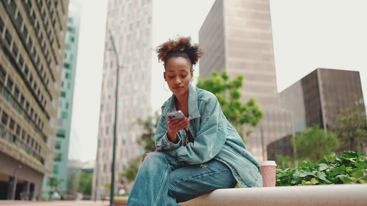 Woman using phone in city