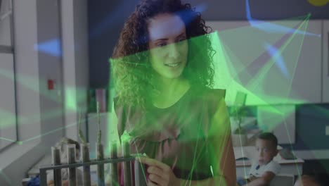 Animation-of-network-over-happy-biracial-female-teacher-with-plants-in-test-tubes-talking-in-class