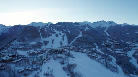 drone shot of telluride, co ski village during sunrise in the winter