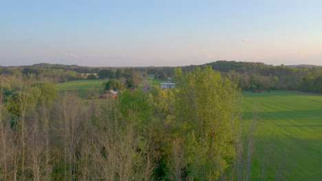 Trees-and-a-modern-farm-near-the-Joseph-Smith-family-farm,-frame-house,-temple,-visitors-center,-and-the-sacred-grove-in-Palmyra-New-York-Origin-locations-for-the-Mormons-and-the-book-of-Mormon